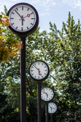 Classic black and white analog clocks with synchronized time show teamwork and synced project...