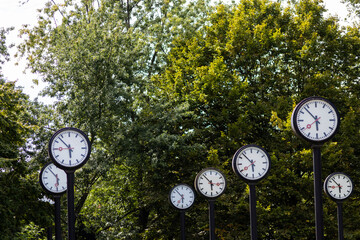 Classic black and white analog clocks with synchronized time show teamwork and synced project...