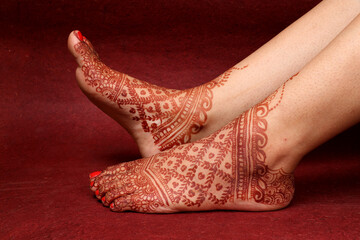 Beautiful henna or mehendi decoration on a hindu bride's hand & Feet | Isolated hand & feet with...