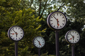 Classic black and white analog clocks with synchronized time show teamwork and synced project...