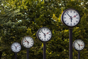 Classic black and white analog clocks with synchronized time show teamwork and synced project...