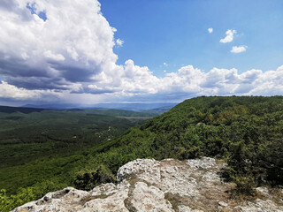 The high mountain offers scenic views of green valleys, hills and forests