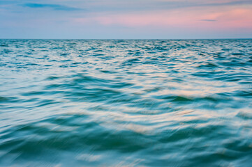 Fototapeta na wymiar Abstract sea background, long exposure view of dreamy ocean or sea coast in summer. Sunset. Motion blur.