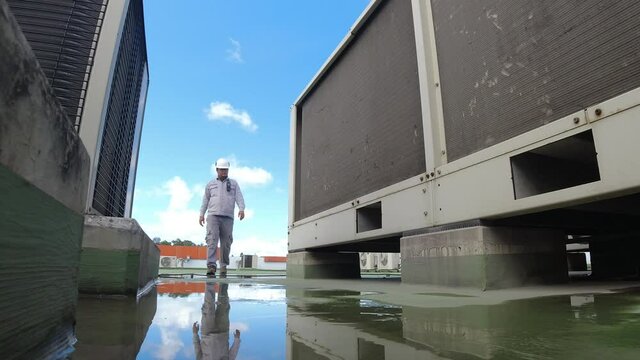 Service engineer to check the air condition system on the rooftop of building