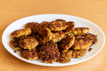 Homemade cutlets,meatballs white plate on a table yellow background.Delicious homemade cutlets.Selective focus.