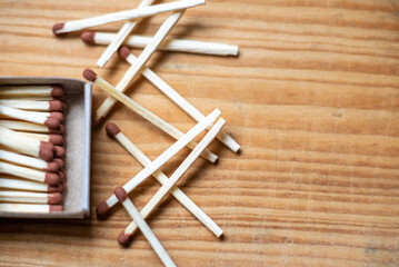 Matches in box on wooden background. Closeup shot. Matchsticks in open match-box flat lay,copy space.Selective focus.