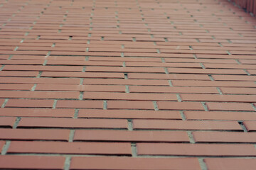 Red brick wall close-up. The outer wall of the building in a receding perspective. Architecture....