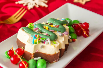 Fototapeta na wymiar Christmas tree ice cream with chocolate, candy and fruit