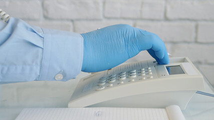 Image with Businessman Hands Wearing Protective Gloves Using Telephone