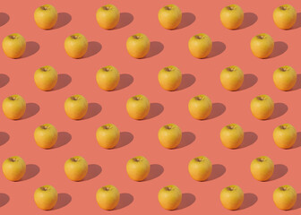 pattern of juicy yellow apples on a pink background