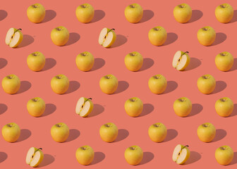 pattern of juicy yellow apples on a pink background