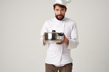 male chef with a saucepan in his hands kitchen recipe dishes