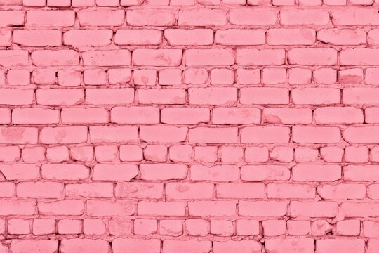 Pastel pink painted old rough brick wall texture. Shabby cement block masonry. Abstract background
