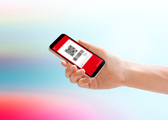 Hand holding a smartphone with a QR code on it.