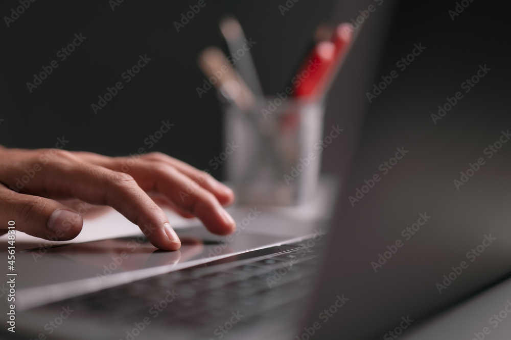 Poster Man using laptop computer working for new idea at desk in the office late at night with copy space