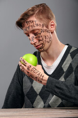 Pensive man holding an apple in his hands