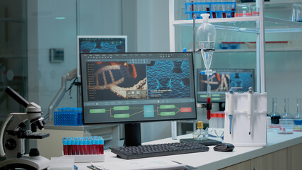 Close up of chemistry desk in laboratory workplace filled with research equipment for...