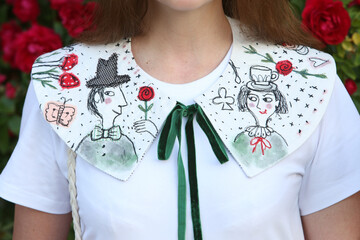 Russian fashion woman, pretty girl in rose garden. Retro look with handmade collar with embroidery, skirt. Street style, lady like style. Summer trendy outfit. Embroidered vintage collar. Retro look