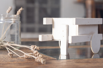 Still life decoration with dried lavender spikes and a small wooden cart