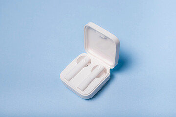 Wireless white headphones on a plain background . White headphones. Solid color background. Modern...