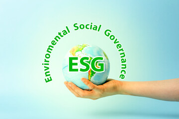 ESG modernization environmental social governance conservation and CSR policy. Earth globe in hands on a blue background. Ecology and nature protection concept. 