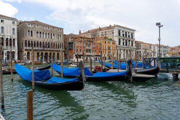 Fototapeta na wymiar Gondolas parked on the Canal Grande in Venice, with the palaces in the background