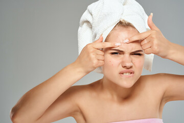 woman with a towel on her head acne on her face dermatology skin care