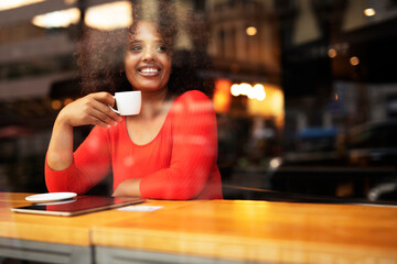 Young woman at cafe drinking coffee. Beautiful woman enjoying in fresh coffee