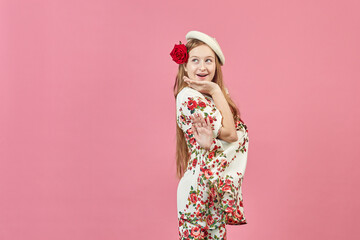 Fashion portrait of a beautiful elegant girl in a pretty dress with flowers on pink background. Young blonde woman in nice spring dress. Fashion spring summer concept.