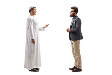 Full length profile shot of a man in ethnic clothes talking to a casual bearded man - obrazy, fototapety, plakaty