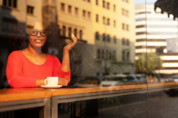 Young woman at cafe drinking coffee. Beautiful woman enjoying in fresh coffee
