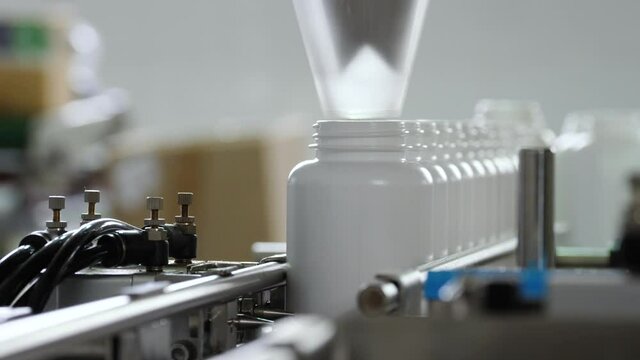 Pharmaceutical production. Medical capsules are moving in a packaging machine.