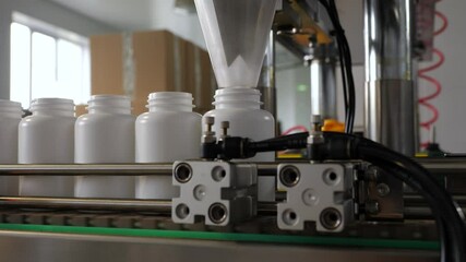 Pharmaceutical production. Medical capsules are moving in a packaging machine. Slow motion 120 fps.