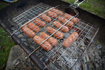 delicious fried sausages on the fire