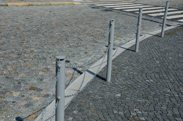 better safety, the cities are equipped with posts on the edge of the sidewalk with chain railing....