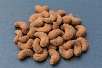Cashew nuts covered with cocoa powder, close up, top view. Balinese dessert, Indonesia, Bali