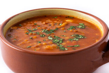 Red lentil soup in bowl isolated on white background.Close up