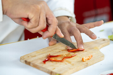 Chef carves patterns on cabbage and other vegetables and fruits for a beautiful table decoration
