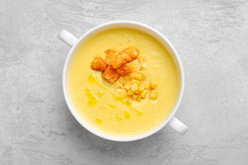 Overhead view of mashed corn soup with croutons