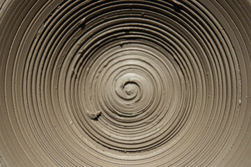 Fototapeta na wymiar Spiral. A clay pot that has just been made by the potter. details