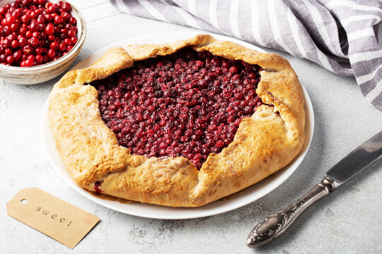 galeta or pie with lingonberries on a white plate, horizontally, homemade cake