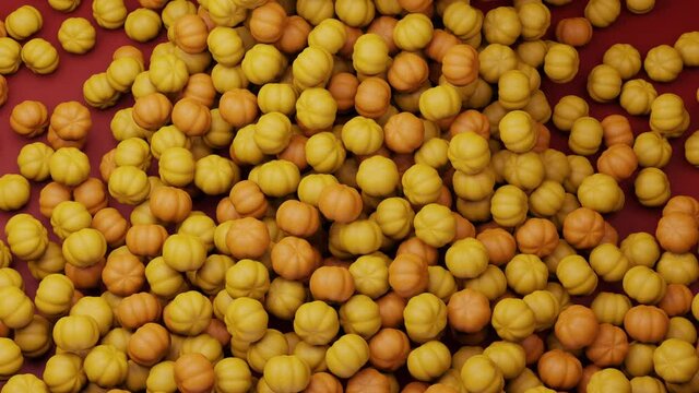 Bright colorful candy beans or peanuts falling down. Pumpkin shape, Halloween celebration yellow colored tasty sugar sweets. Red background. Candies filling all area. Close up. 3D Render 4K animation