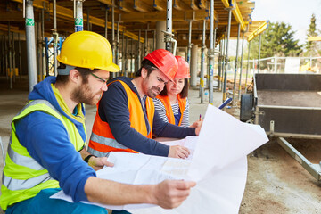 Craftsmen team and architect on the construction site