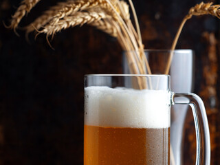 A mug of cold wheat beer, wheat ears in a beer glass