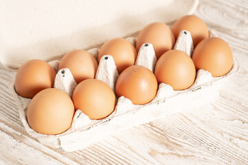 Eco eggs container. Raw chicken eggs in egg box. Cartons packing. Recycling concept. Cardboard egg rack with eggs