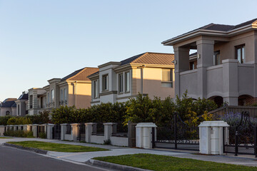 Modern estates behind fences in suburb.
