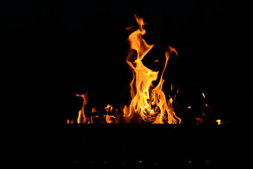 flames at night. Fire flames on black background.  tongues of flame on the background of coals