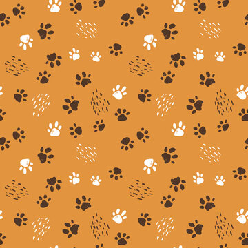 Seamless pattern of dogs, cats or tigers paws. Hand drawn vector illustration on yellow background with lines like scratches