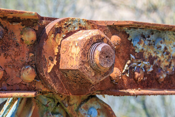 Side view of giant nut and bolt, very old and rusty