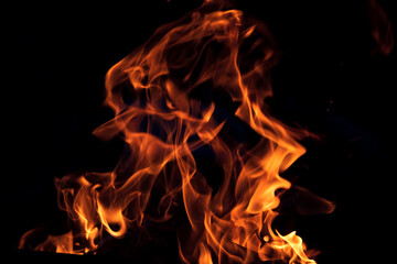 Orange flame on black background. Heat energy heap closely, red and yellow
